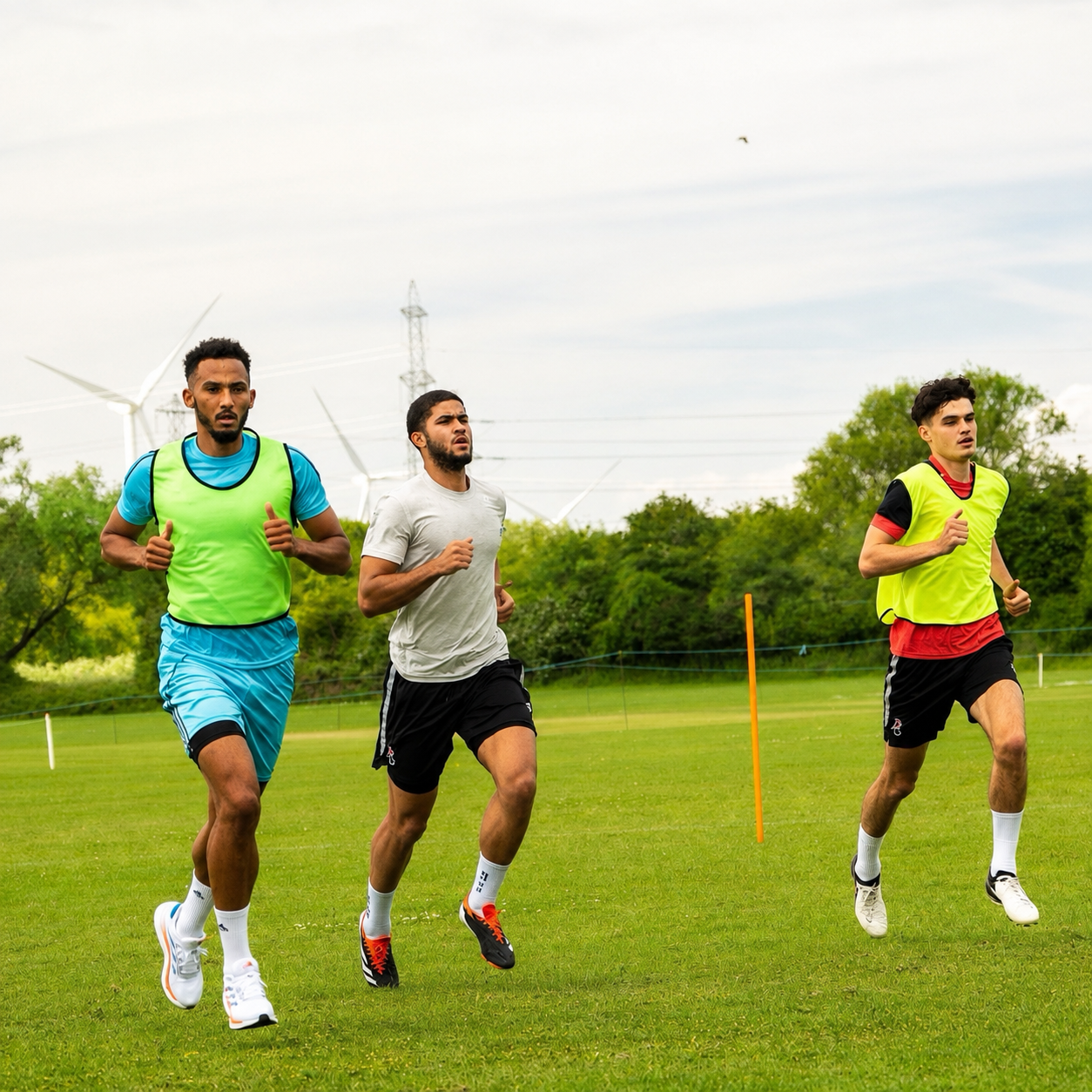 Athletes running pitch-based conditioning at Back2Action